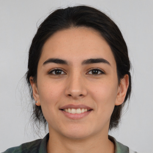 Joyful white young-adult female with medium  black hair and brown eyes