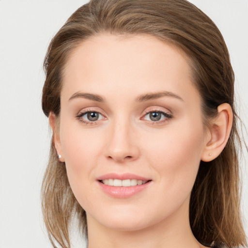 Joyful white young-adult female with long  brown hair and grey eyes