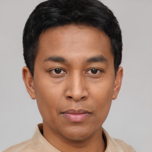 Joyful asian young-adult male with short  black hair and brown eyes