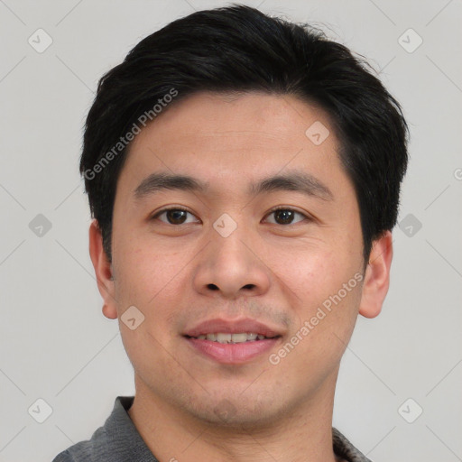 Joyful asian young-adult male with short  black hair and brown eyes