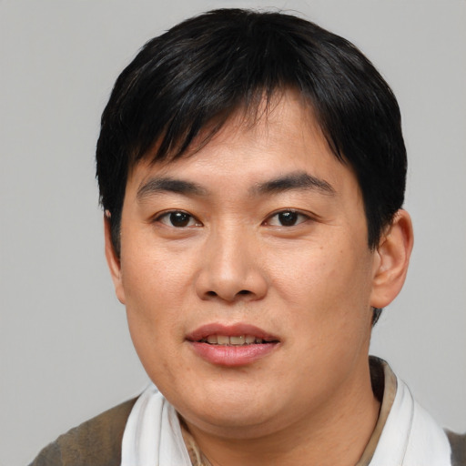 Joyful asian young-adult male with short  black hair and brown eyes