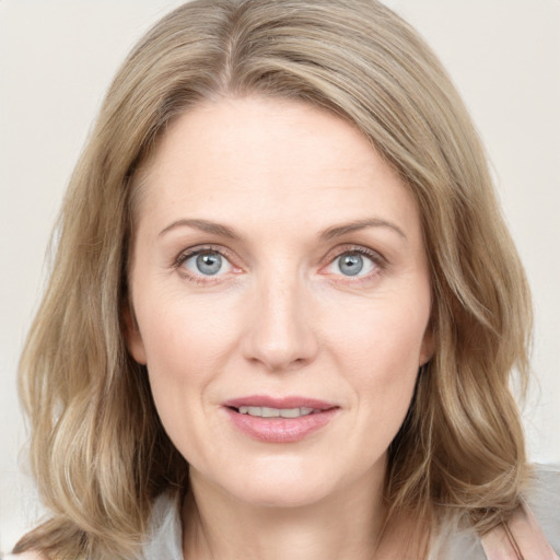 Joyful white young-adult female with medium  brown hair and blue eyes