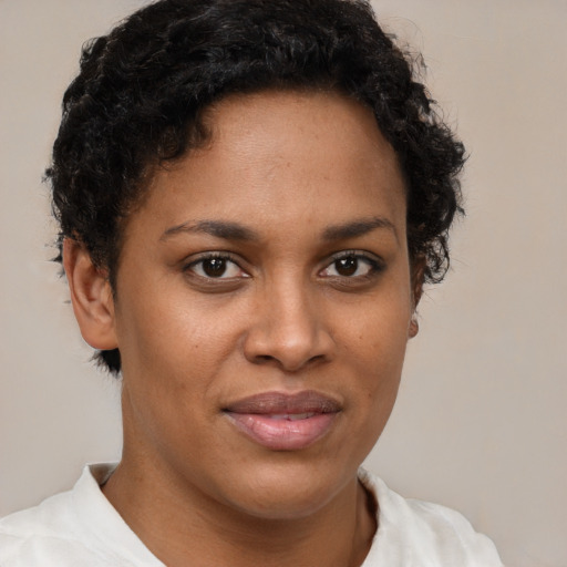 Joyful latino young-adult female with short  brown hair and brown eyes