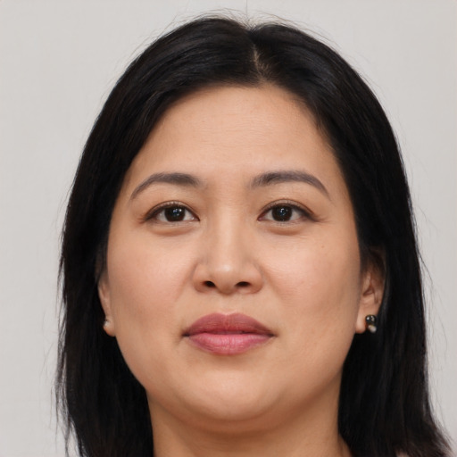 Joyful asian young-adult female with long  brown hair and brown eyes