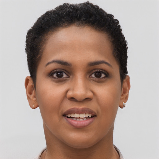 Joyful black young-adult female with short  brown hair and brown eyes