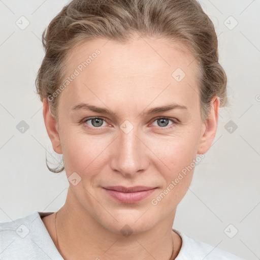 Joyful white young-adult female with short  brown hair and blue eyes