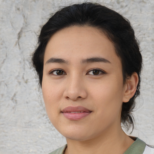 Joyful asian young-adult female with medium  brown hair and brown eyes