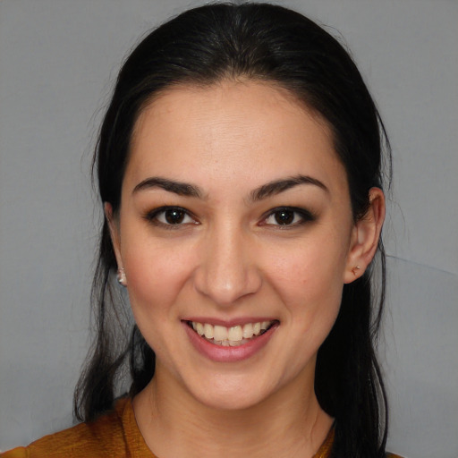 Joyful white young-adult female with long  brown hair and brown eyes