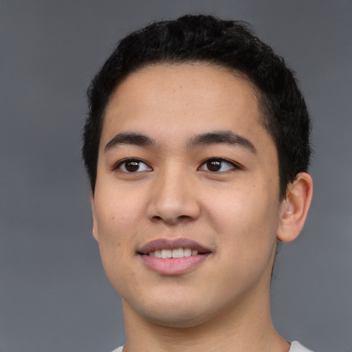 Joyful white young-adult male with short  black hair and brown eyes