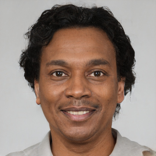 Joyful latino adult male with short  brown hair and brown eyes