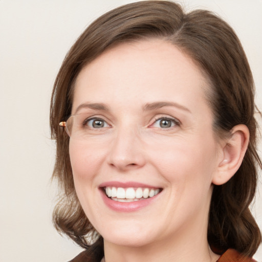 Joyful white young-adult female with medium  brown hair and blue eyes