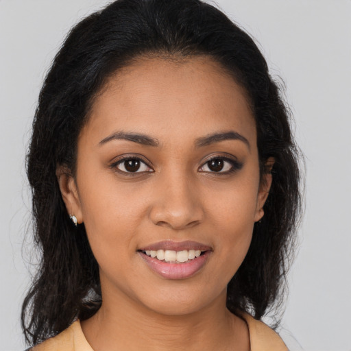 Joyful latino young-adult female with long  brown hair and brown eyes