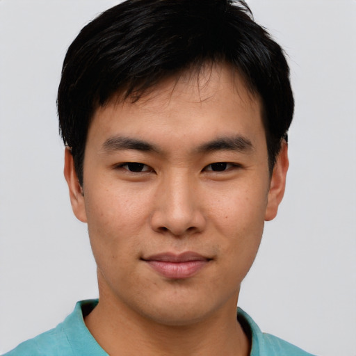Joyful asian young-adult male with short  black hair and brown eyes