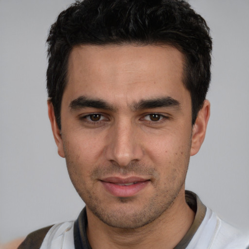 Joyful white young-adult male with short  black hair and brown eyes