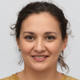 Joyful white young-adult female with medium  brown hair and brown eyes