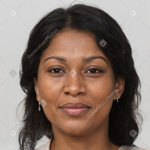 Joyful black adult female with medium  brown hair and brown eyes