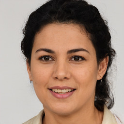 Joyful latino young-adult female with medium  brown hair and brown eyes