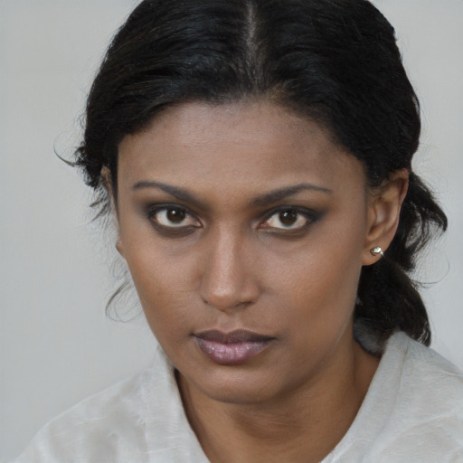 Neutral black young-adult female with medium  brown hair and brown eyes
