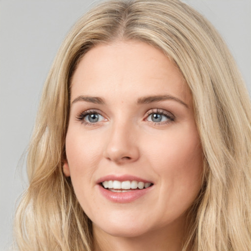 Joyful white young-adult female with long  brown hair and blue eyes