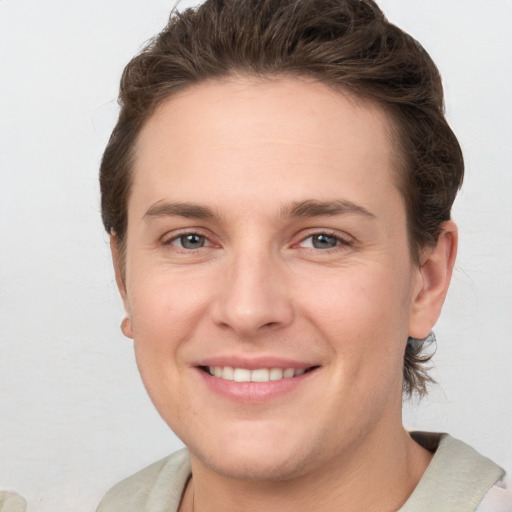 Joyful white young-adult female with short  brown hair and grey eyes