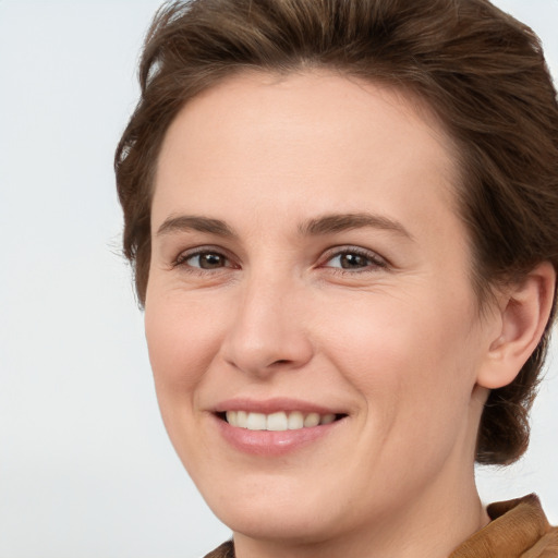 Joyful white young-adult female with short  brown hair and grey eyes