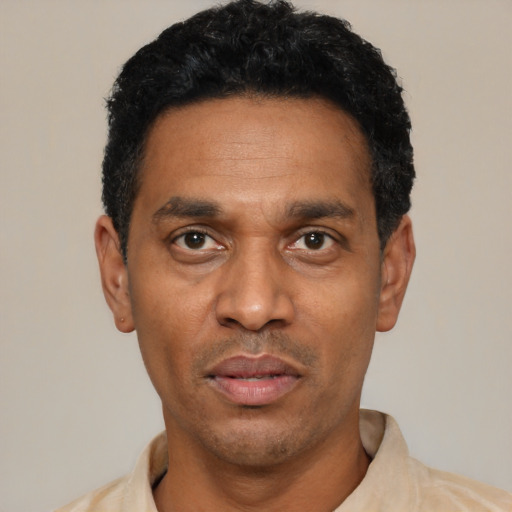 Neutral latino adult male with short  black hair and brown eyes