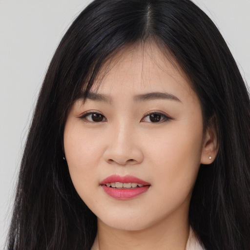 Joyful asian young-adult female with long  black hair and brown eyes