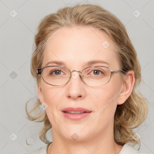 Joyful white adult female with medium  brown hair and blue eyes