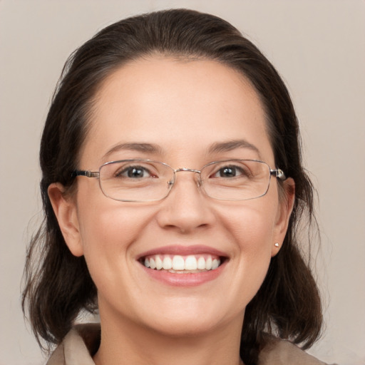 Joyful white adult female with medium  brown hair and grey eyes