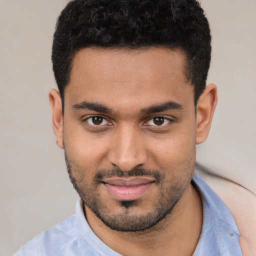 Joyful white young-adult male with short  black hair and brown eyes