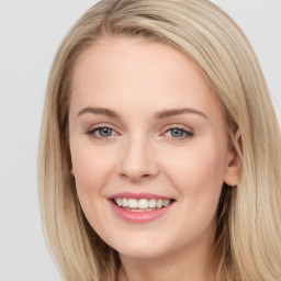 Joyful white young-adult female with long  brown hair and blue eyes