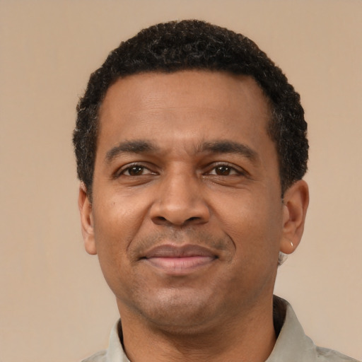 Joyful latino adult male with short  black hair and brown eyes