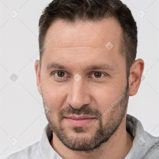 Joyful white adult male with short  brown hair and brown eyes