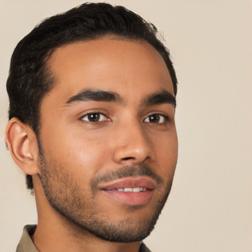 Joyful latino young-adult male with short  brown hair and brown eyes