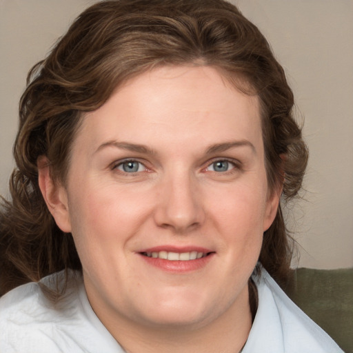 Joyful white young-adult female with medium  brown hair and blue eyes