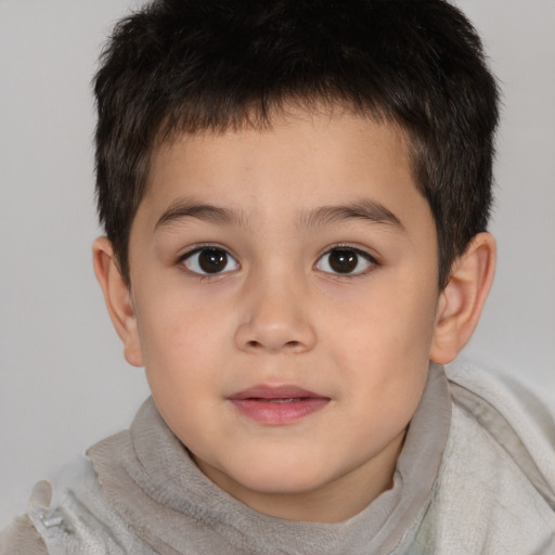 Joyful white child male with short  brown hair and brown eyes