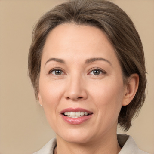 Joyful white adult female with medium  brown hair and brown eyes