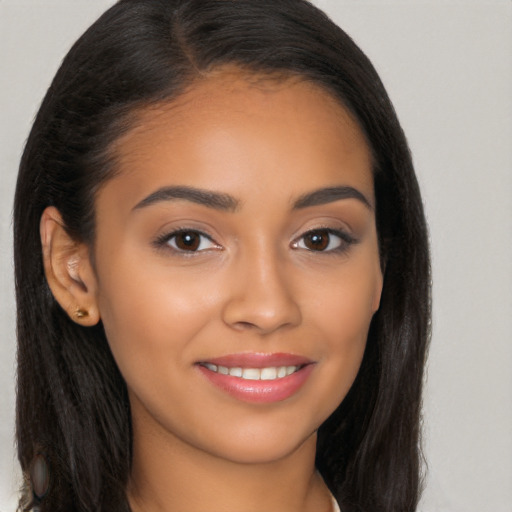 Joyful latino young-adult female with long  brown hair and brown eyes