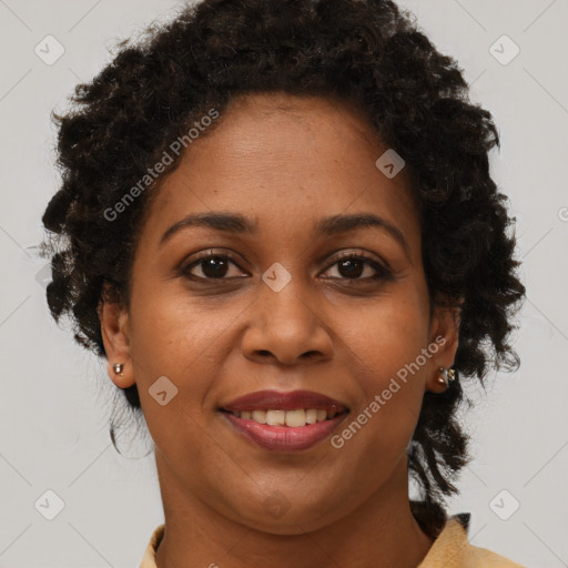 Joyful black adult female with medium  brown hair and brown eyes