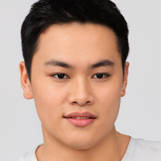 Joyful asian young-adult male with short  black hair and brown eyes