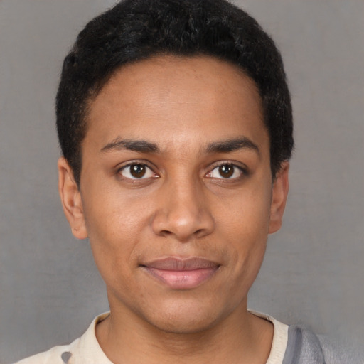 Joyful black young-adult male with short  black hair and brown eyes
