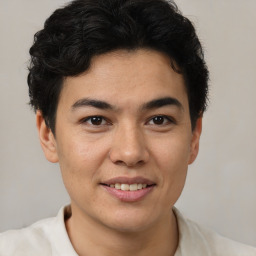 Joyful latino young-adult male with short  brown hair and brown eyes