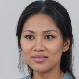 Joyful latino young-adult female with medium  brown hair and brown eyes