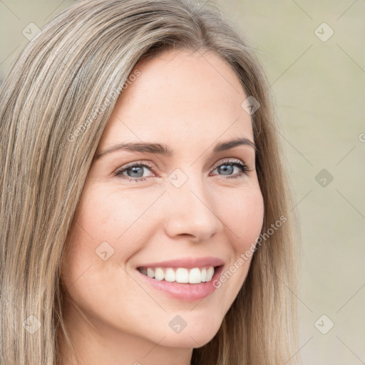 Joyful white young-adult female with long  brown hair and green eyes