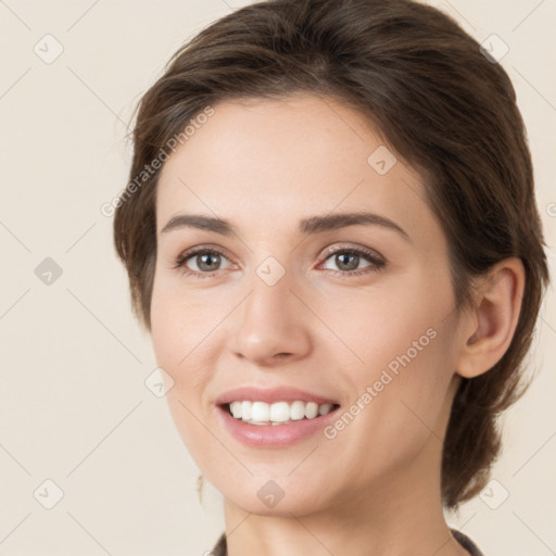 Joyful white young-adult female with medium  brown hair and grey eyes