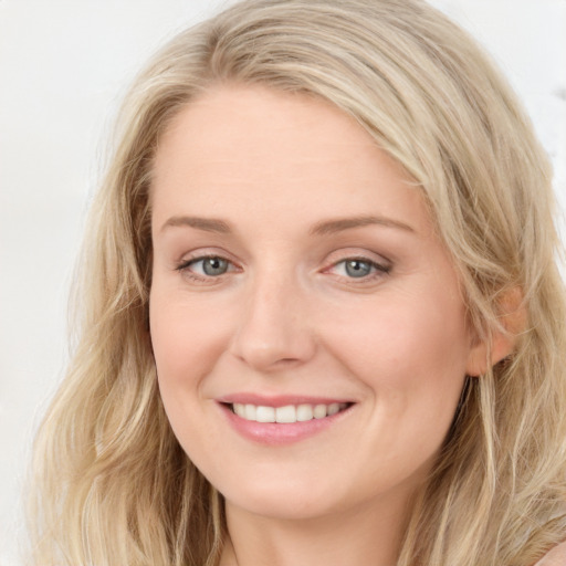 Joyful white young-adult female with long  brown hair and blue eyes