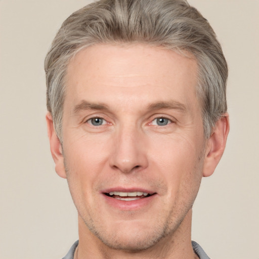 Joyful white adult male with short  brown hair and grey eyes