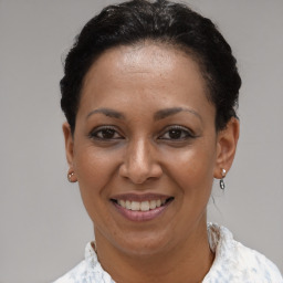 Joyful latino young-adult female with short  brown hair and brown eyes