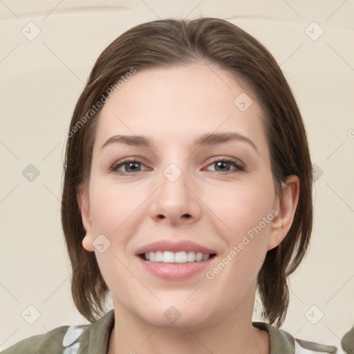 Joyful white young-adult female with medium  brown hair and grey eyes