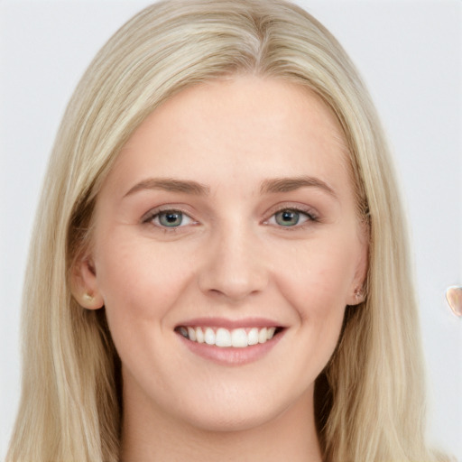 Joyful white young-adult female with long  brown hair and blue eyes